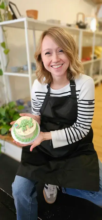 Participant holding a decorated cake