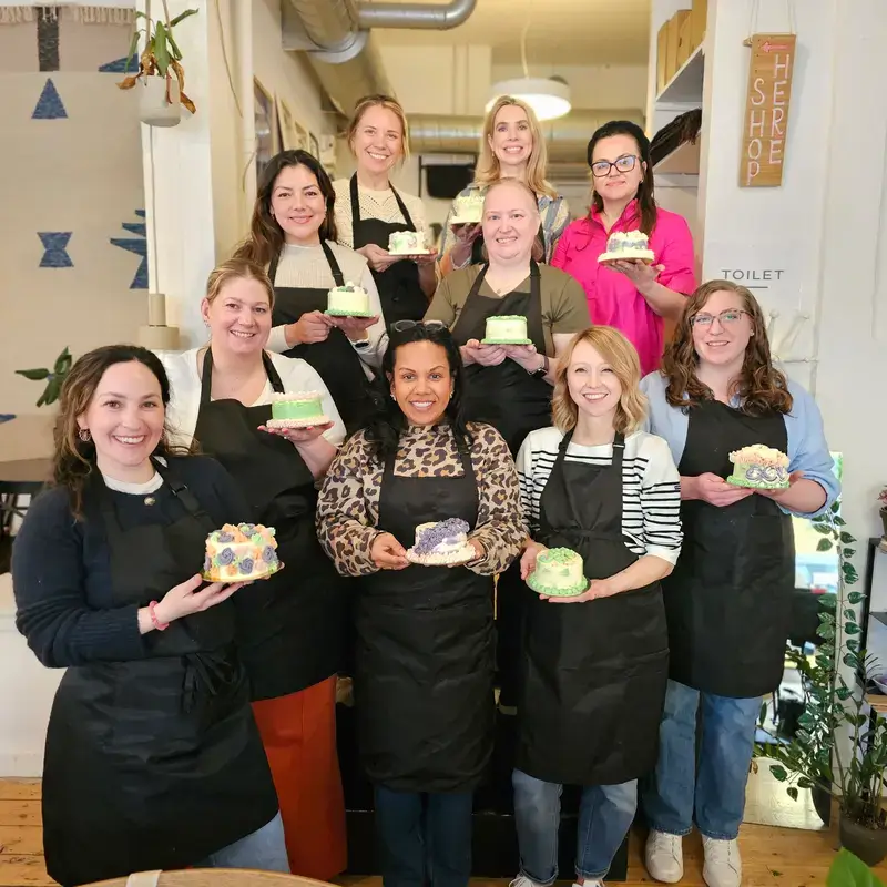 Beginner workshop group holding cakes
